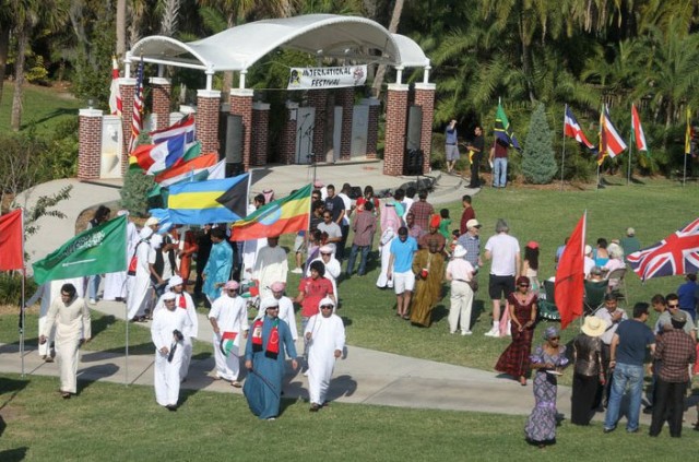 Students holding flags representing their country
